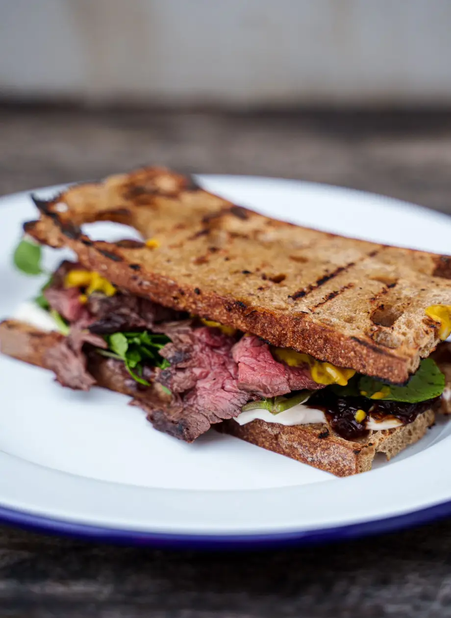 Pink Carved steak sandwich on sour dough bread