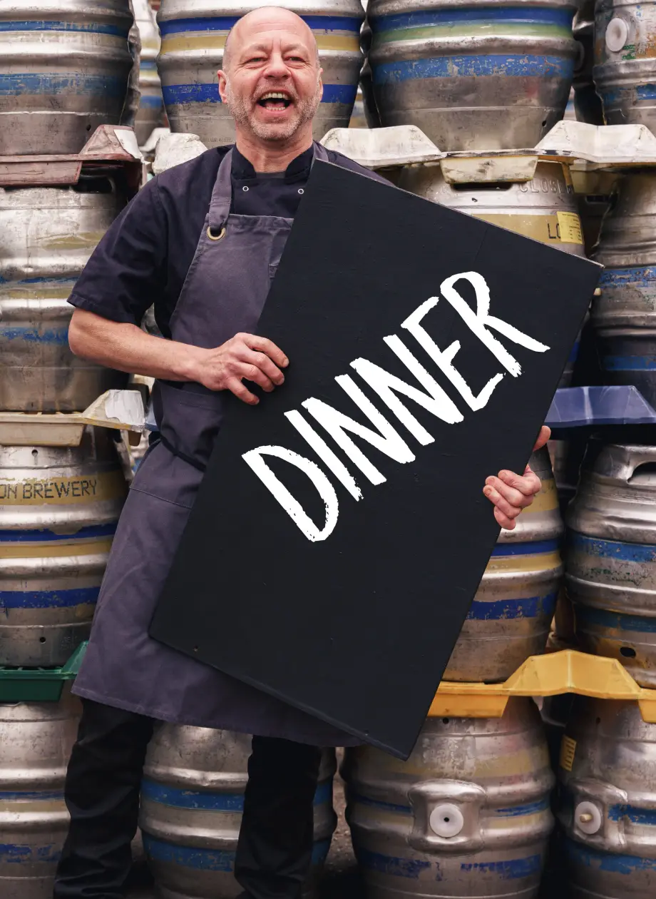 Nick chef holding up dinner menu board