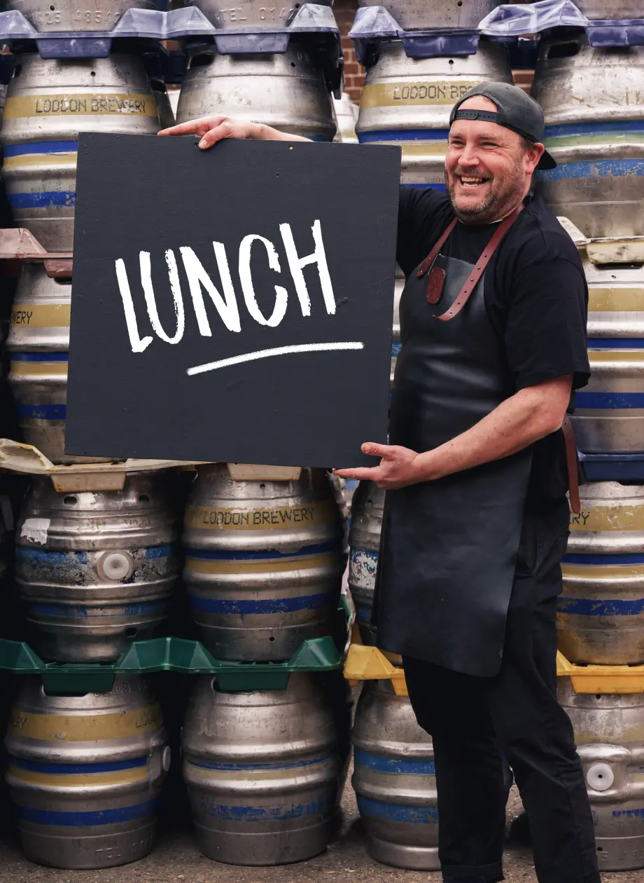 James chef holding up lunch menu board