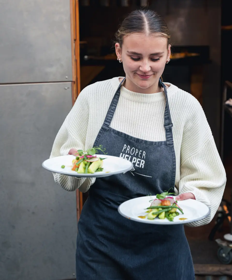 Waitress serving food for Proper Kitchen